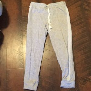 Gray sweatpants with a white strip down the sides